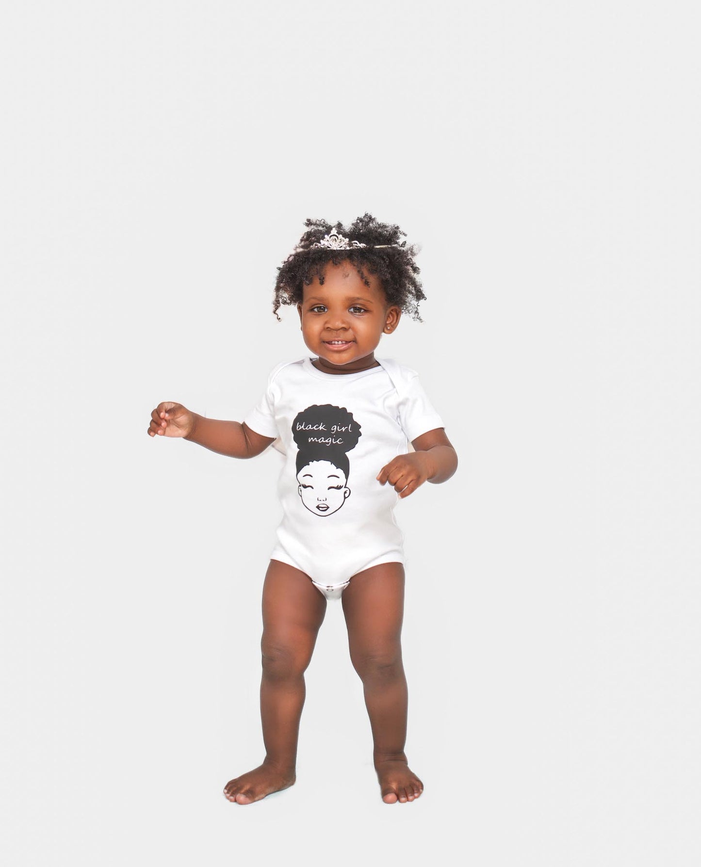 Black Girl Magic Onesie with illustration of melanated girl with an afro, available in white, and pink
